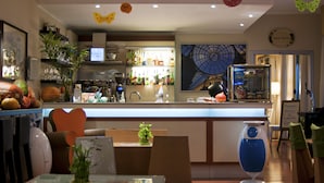 A restaurant with a bar area, a wine room sign, and a large decorative clock on the wall. - eco Hotel Milano & BioRiso Restaurant (Milan)