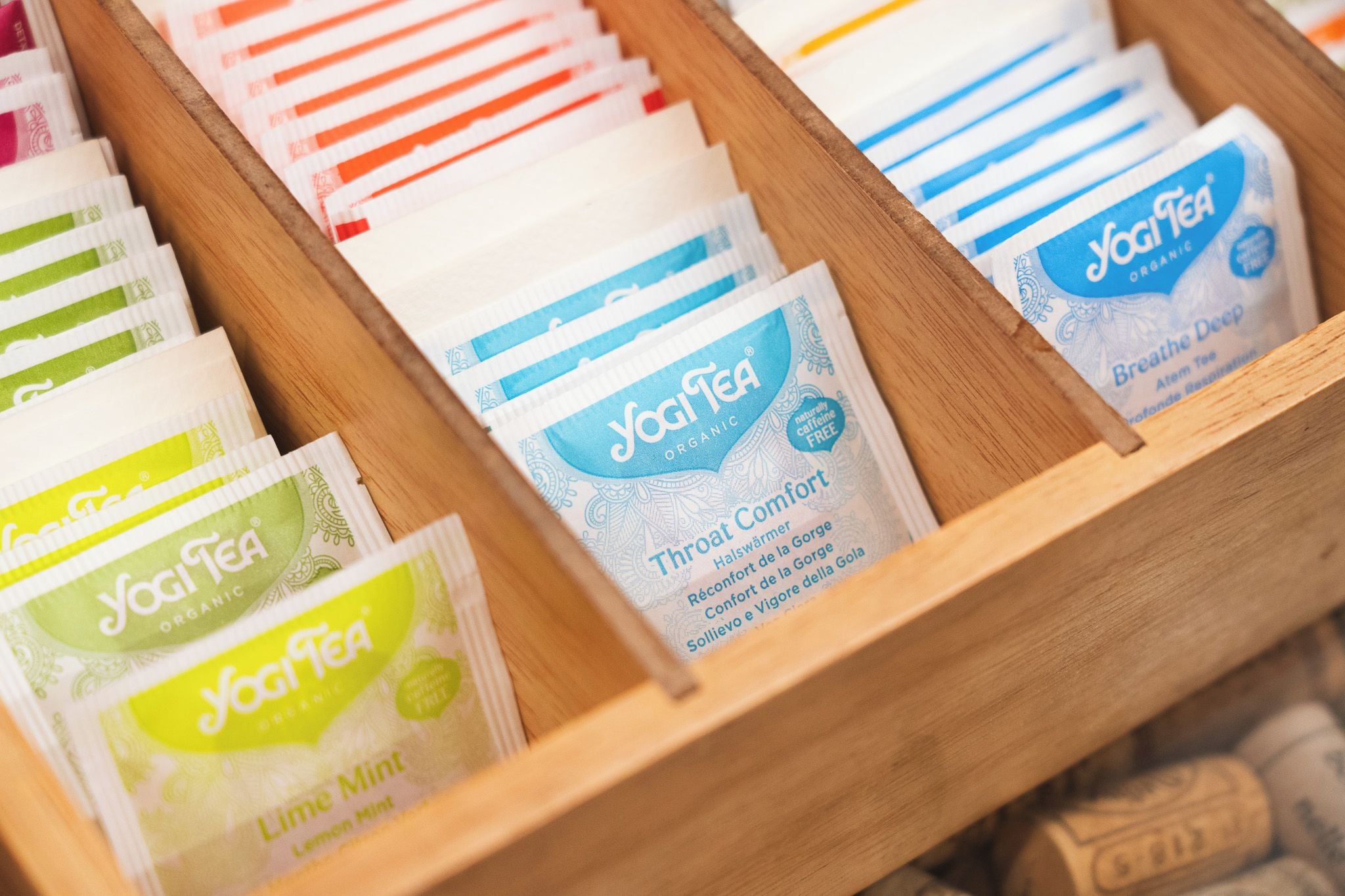A wooden box containing various Yogi Tea products.