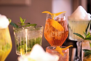 Variedad de vasos con bebidas, adornos y cubitos de hielo.