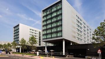 Stylish building with a covered entrance and grid-patterned windows.