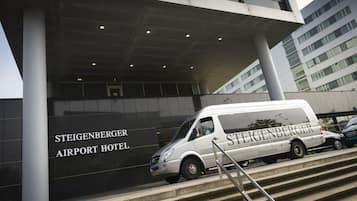 A van parked at the Steigenberger Airport Hotel entrance.