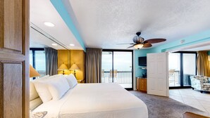 A spacious hotel room with a large bed, a ceiling fan, and a balcony with a view. - SunDestin Beach Resort (Destin)