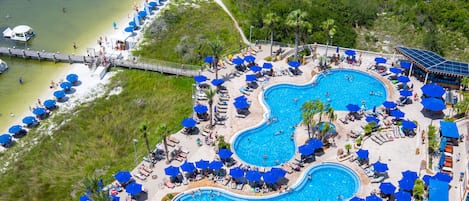 A resort with multiple swimming pools, sun loungers, and umbrellas.