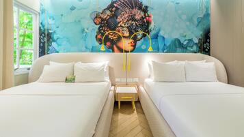 A hotel room with two beds, a mural on the wall, and a window with a view of greenery.