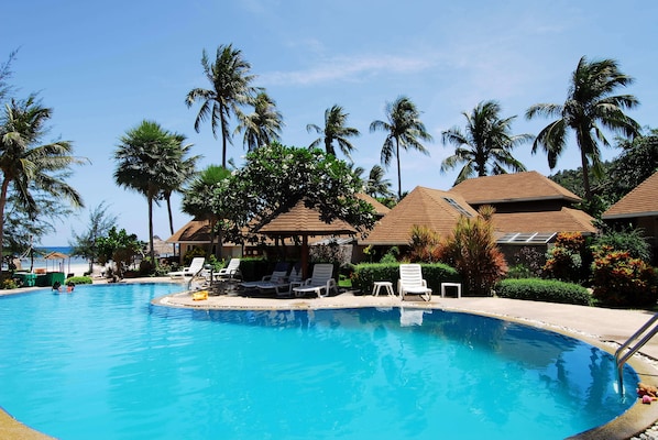 Una piscina al aire libre, sombrillas