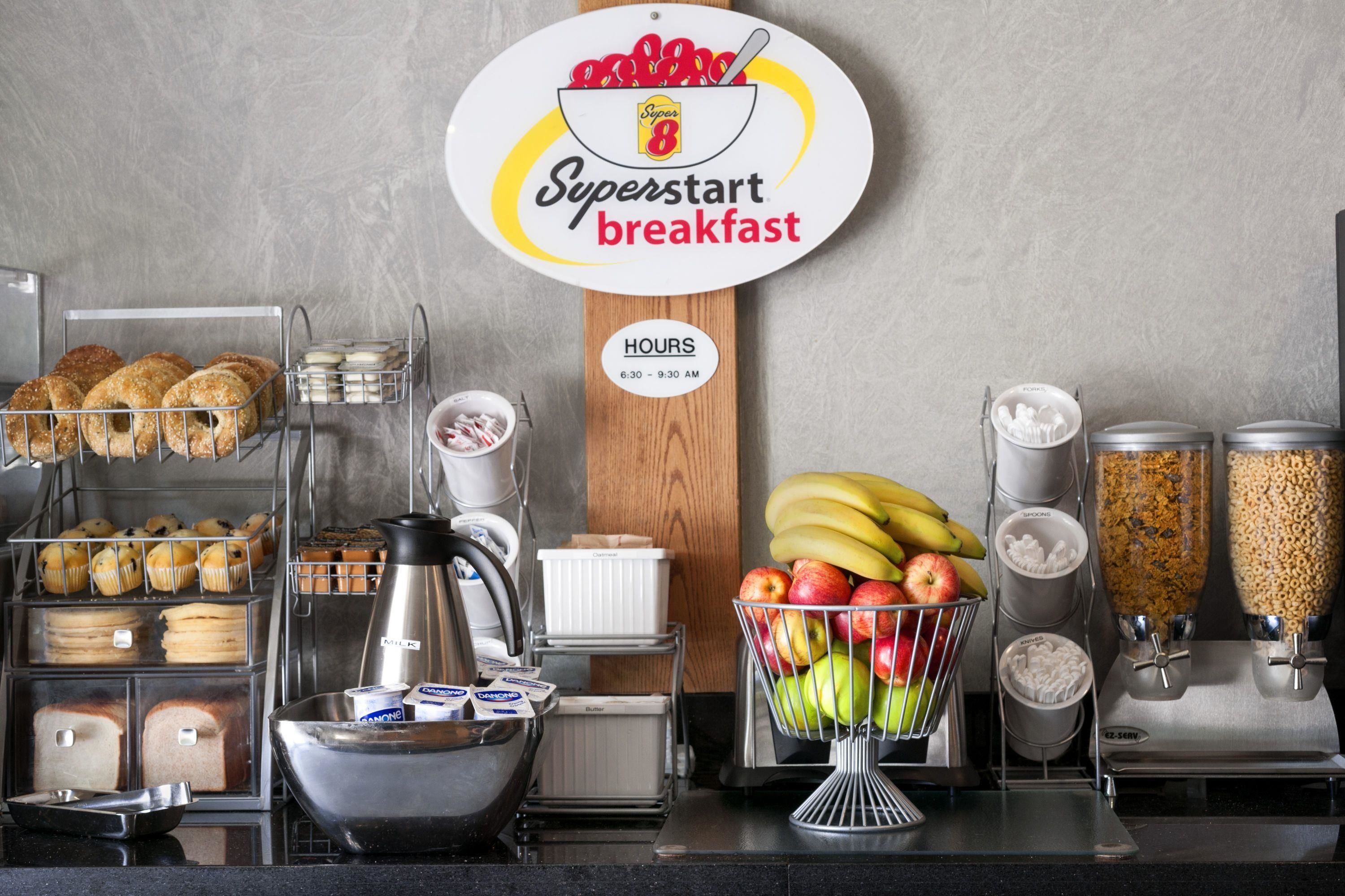 A breakfast station with a sign indicating 'Superstart breakfast' and operating hours from 6:30 to 9:30 AM.