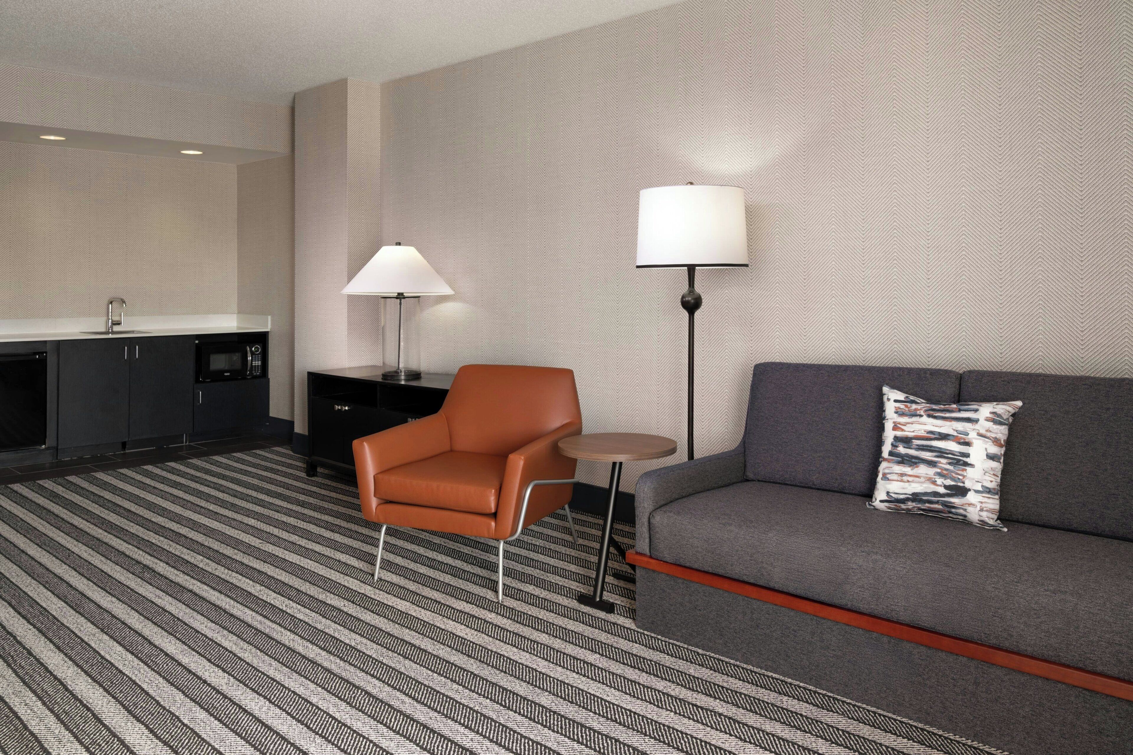 Signature Suite, 1 Bedroom | Living room | 24-inch flat-screen TV with cable channels, TV, iPod dock