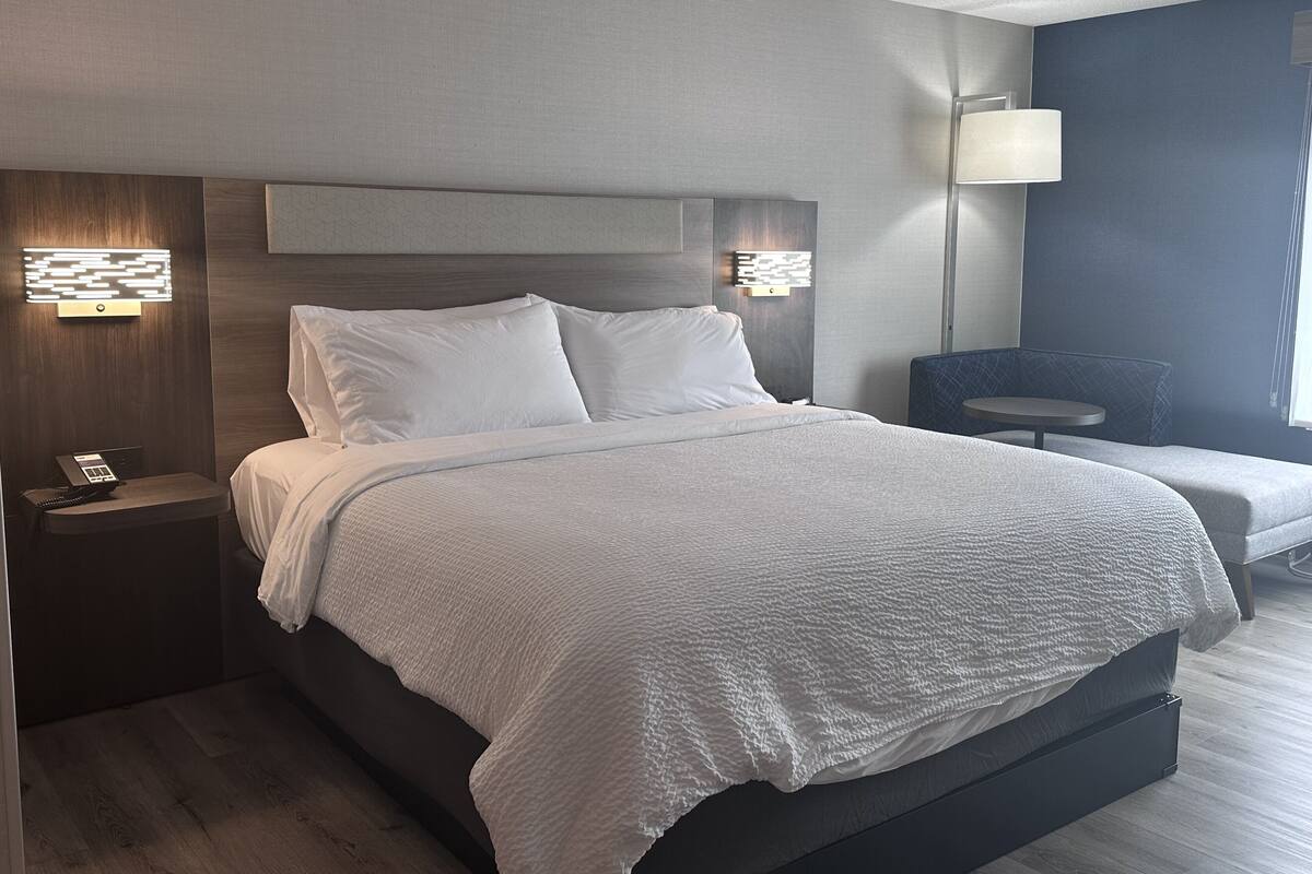Premium bedding, desk, laptop workspace, blackout drapes