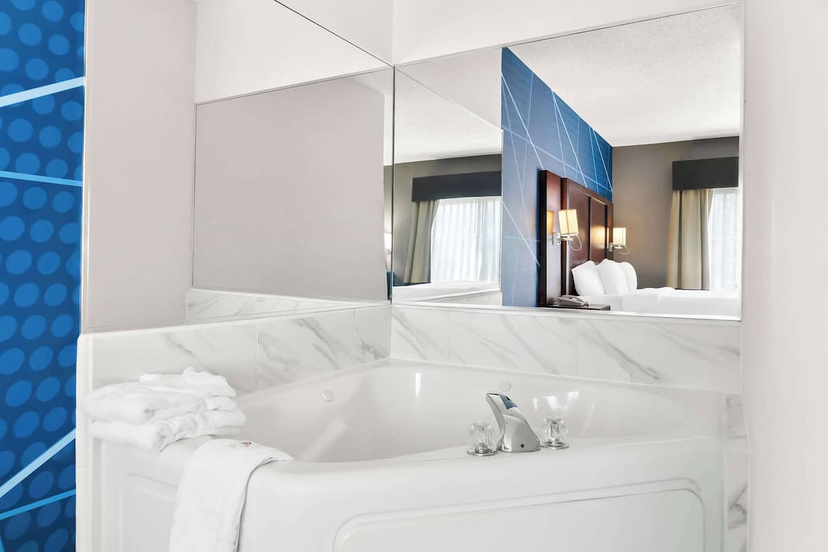 Premium bedding, desk, laptop workspace, blackout curtains