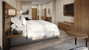 A modern hotel room with a bed, bedside table, lamp, and a desk with a chair. - Holiday Inn Express & Suites Southfield Detroit by IHG (Southfield)