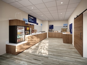 A modern breakfast area with a refrigerated display, a fruit and cereal section, and a bread display.