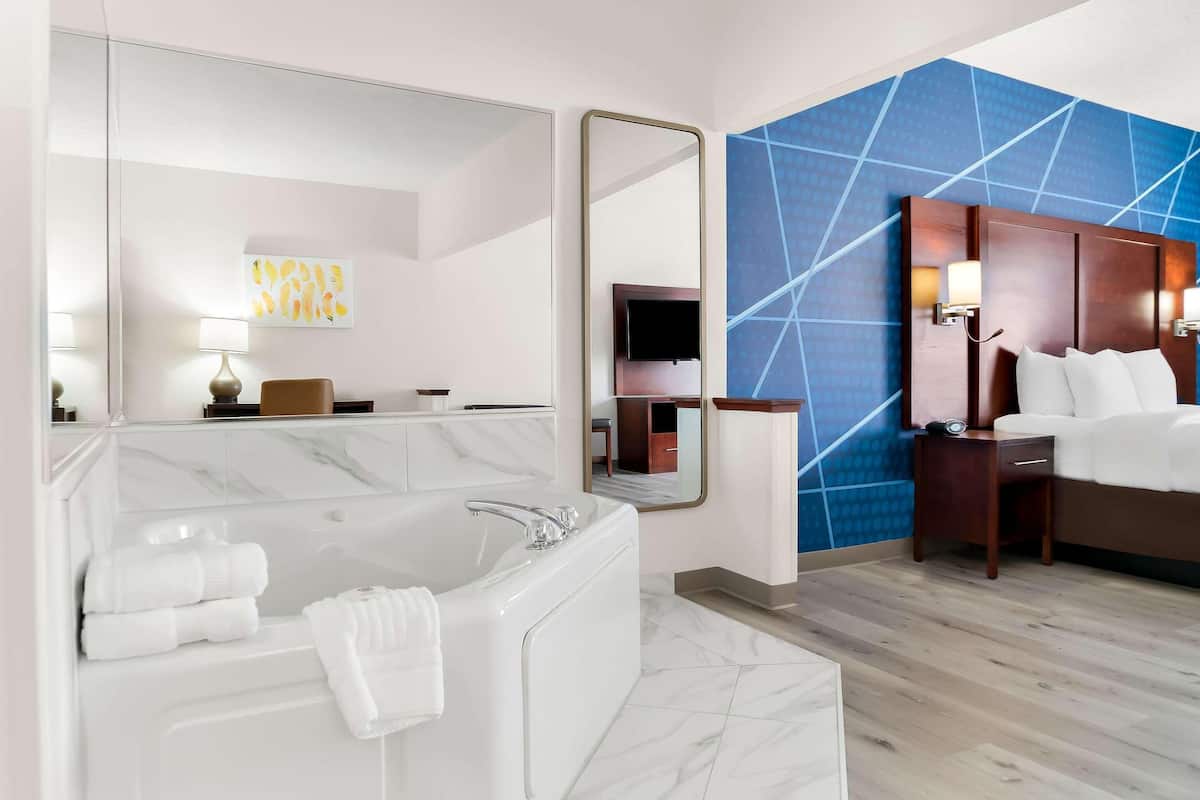 Premium bedding, desk, laptop workspace, blackout curtains
