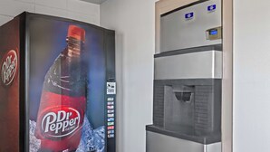 A Dr. Pepper vending machine and a water dispenser in a commercial setting. - Red Roof Inn Abingdon (Abingdon)