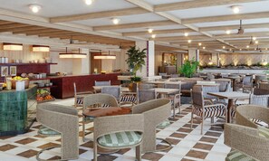 A spacious cafe with high ceilings, wooden beams, and a checkered floor.