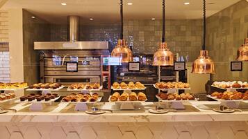A bakery display with various pastries and baked goods.