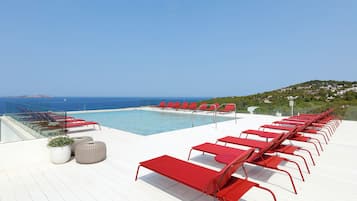Relax on the ocean-view deck with lounge chairs and a scenic view of the coastline.