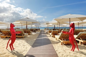 On the beach, sun loungers, beach umbrellas, beach towels