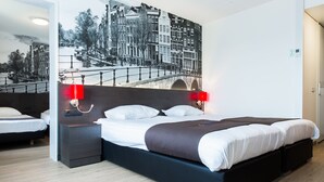 A modern hotel room with a large bed, wooden flooring, a cityscape mural on the wall, and two bedside lamps. - Bastion Hotel Amsterdam Amstel (Amsterdam-Duivendrecht)