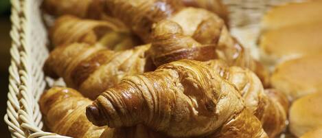 A wicker basket filled with croissants.