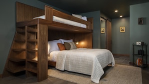A bunk bed with a wooden ladder, a white bedspread, and a small shelf unit beside it. - Hotel Marina Riviera (Big Bear Lake)