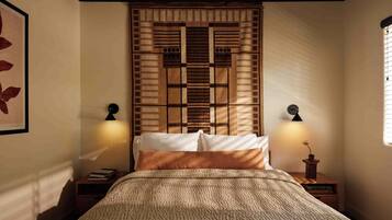 A bedroom with a bed, two bedside tables, a wall-mounted clock, and a decorative panel above the bed.