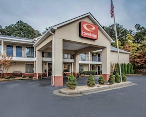 A two-story EconoLodge building with a central entrance, a parking lot, and a flagpole. - Econo Lodge Villa Rica (Villa Rica)
