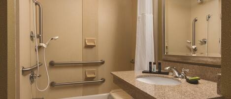 A bathroom with a bathtub, a sink, and a shower.