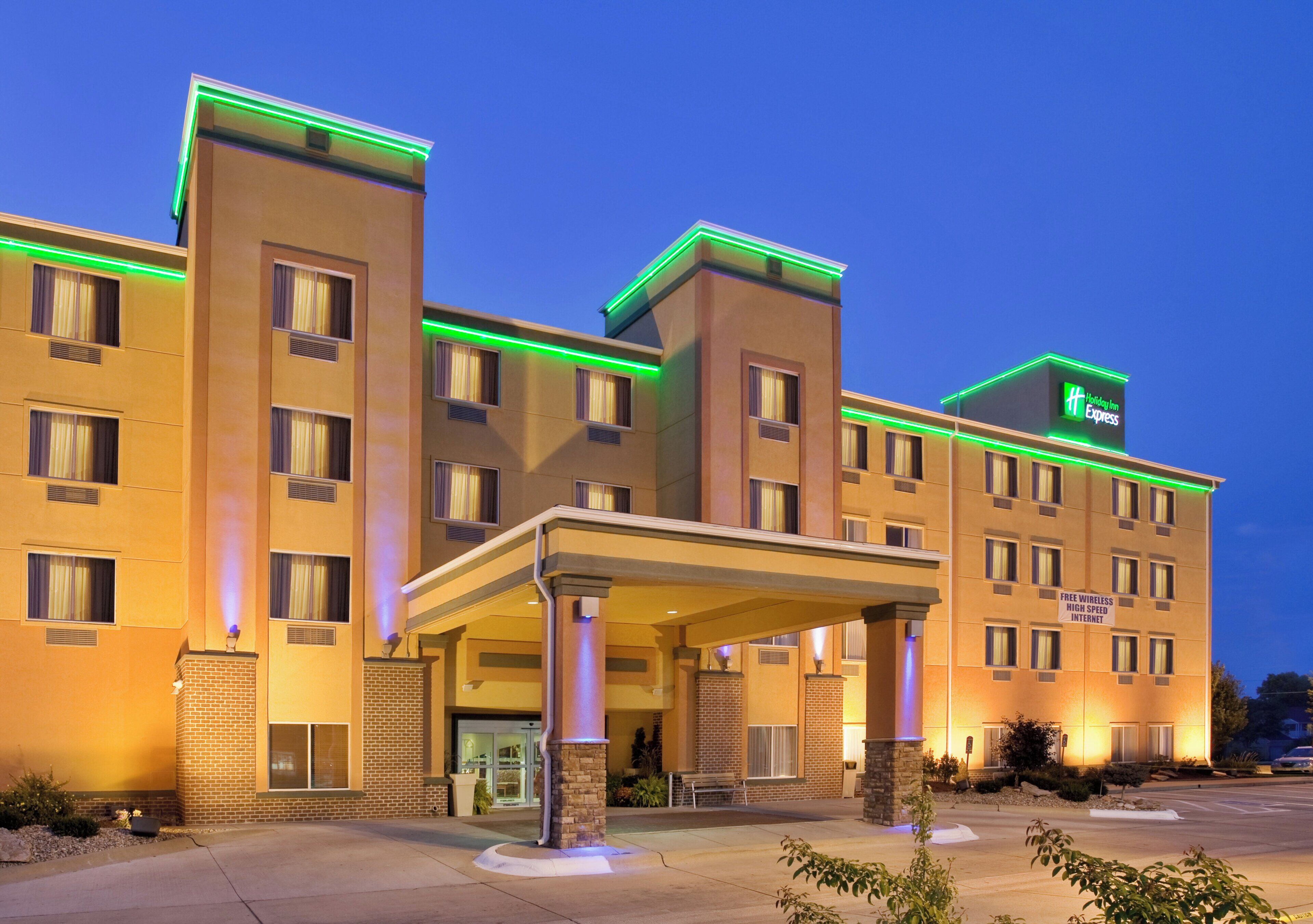 A Holiday Inn Express hotel with a covered entrance, multiple windows, and a brick facade.