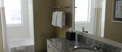 A bathroom with a toilet, sink, and bathtub.