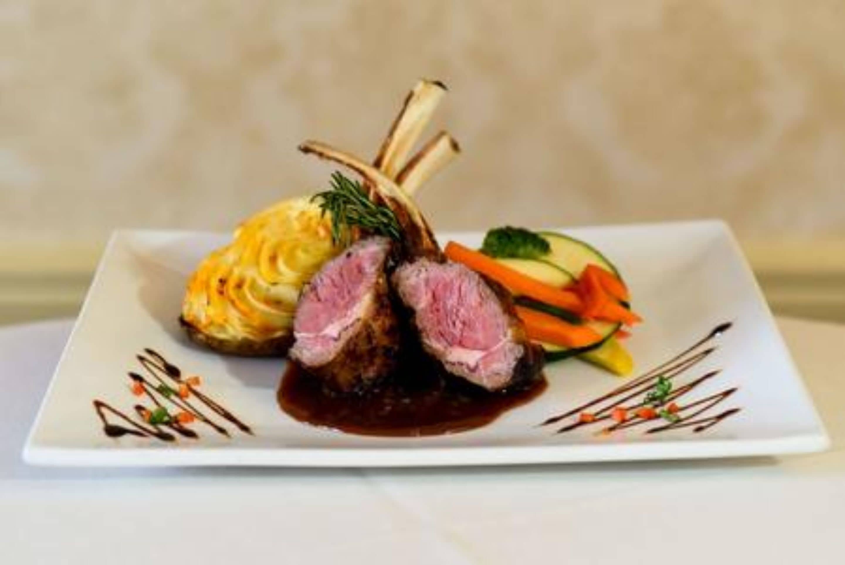 A plated dish with meat, vegetables, and a sauce.