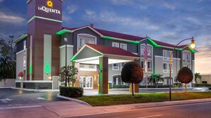A La Quinta hotel with a modern design, featuring a prominent entrance with a covered walkway and a well-lit facade. - La Quinta Inn & Suites by Wyndham Tampa Bay Area-Tampa South (Tampa)