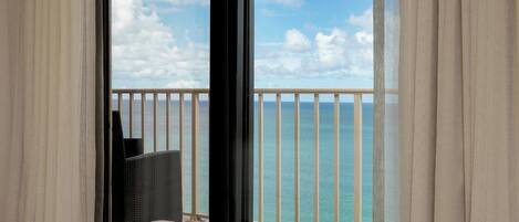 A balcony with a view of the sea and sky.