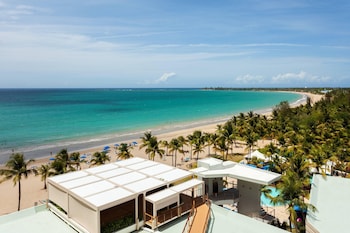In-room safe, desk, laptop workspace, blackout drapes at Courtyard by Marriott Isla Verde Beach Resort