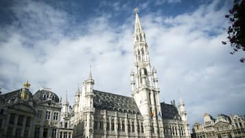 A historic building with intricate architecture, including a prominent tower and multiple spires.