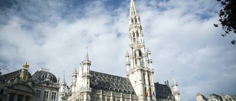 A historic building with intricate architecture, including a prominent tower and multiple spires.