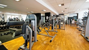 A gym with various exercise equipment, including weight machines and free weights. - Thon Residence Parnasse (Brussels)