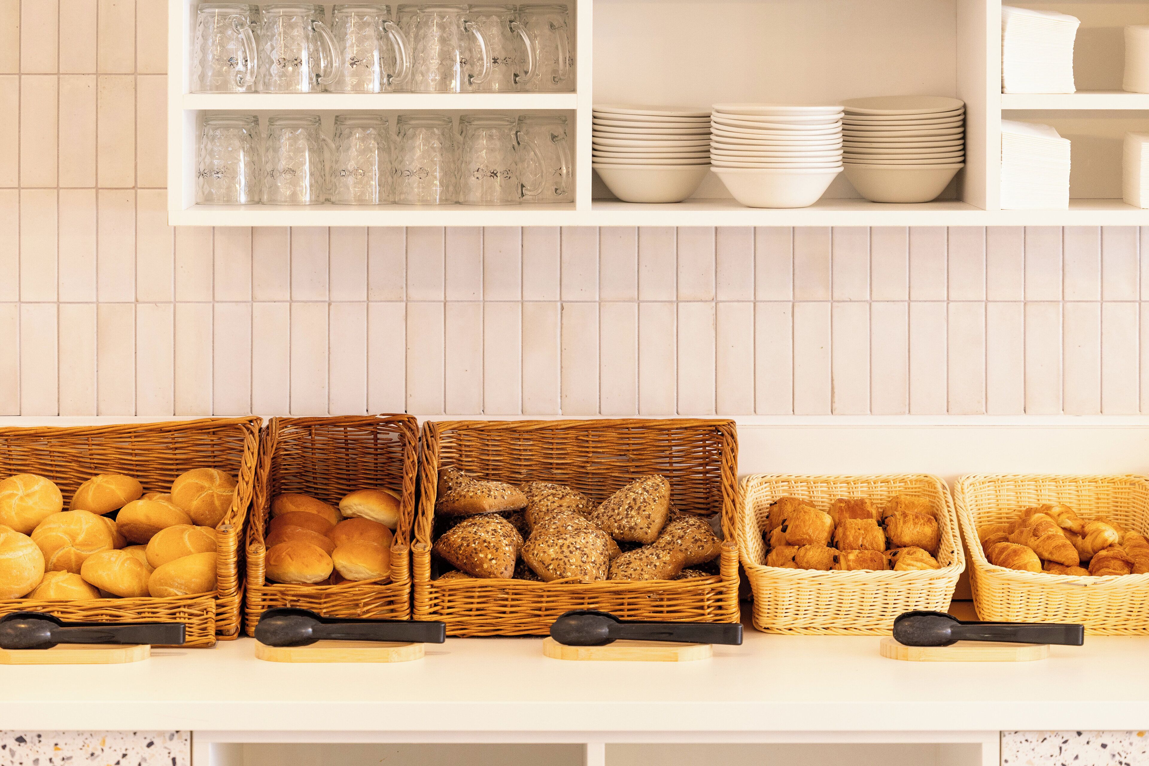 A kitchen counter with various food items and kitchenware.