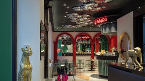 Ein Restaurant mit modernem Interieur, das eine Theke mit Spiegel und eine dekorative Tierstatue zeigt.