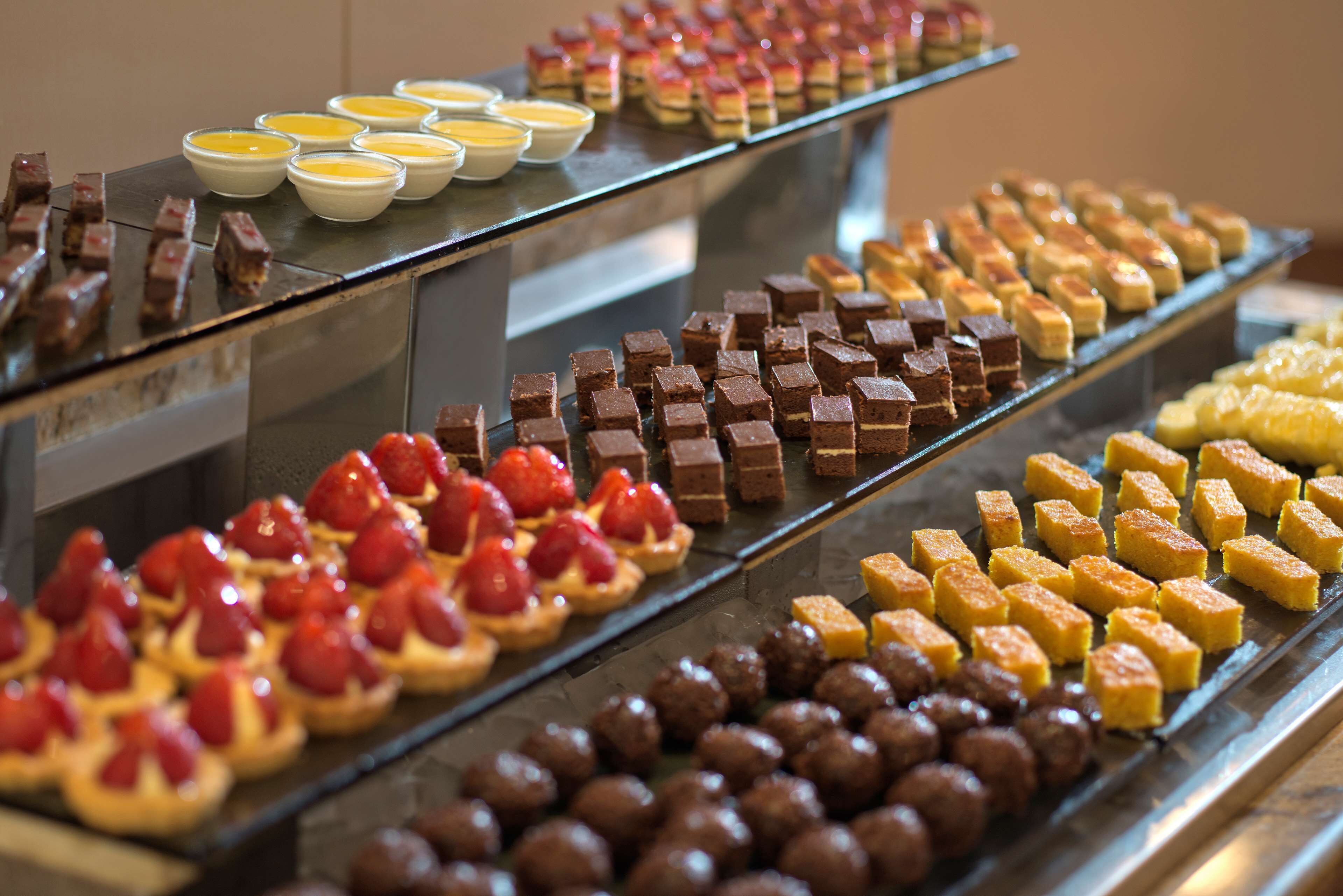 A dessert display with various types of pastries and sweets.