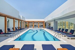 A pool area with lounge chairs and a clear view of the sky. - Al Maha Arjaan By Rotana (Abu Dhabi)