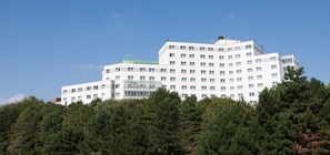 A multi-story hotel with a modern design, featuring a prominent sign for Panorama Inn.