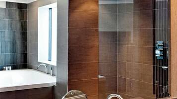 Suite, 1 King Bed, City View | Bathroom | Separate tub and shower, designer toiletries, hair dryer, bathrobes