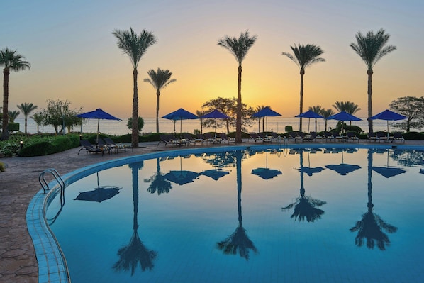 4 outdoor pools, open 7:00 AM to 5:00 PM, pool umbrellas, sun loungers