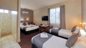A hotel room with two beds, a small table with chairs, a TV, and a window with curtains. - Silver Haven Motor Inn (Broken Hill)