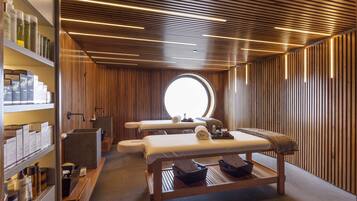 Experience a serene spa retreat with a self-service area featuring massage tables and a selection of products.