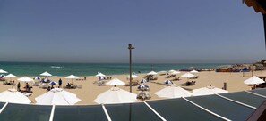 Beach nearby, white sand, beach umbrellas