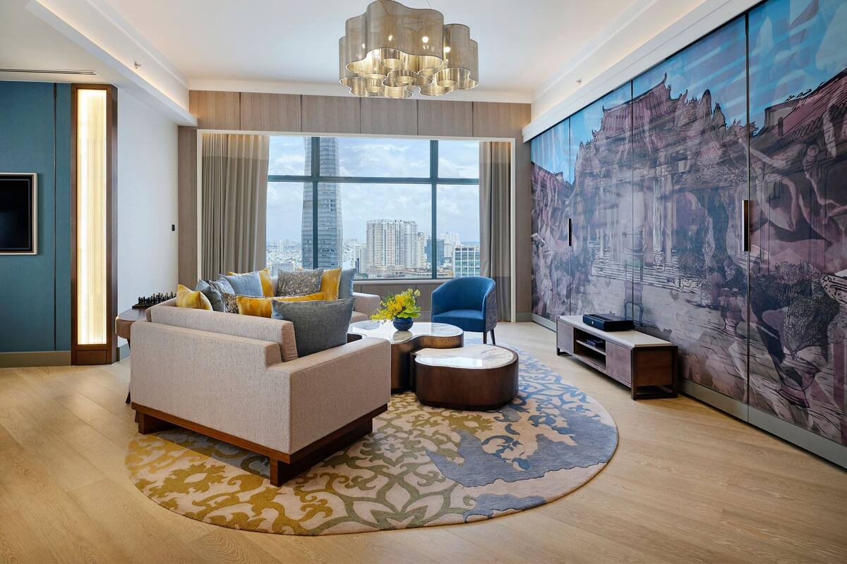A modern living room with a sofa, coffee table, and artwork on the wall.