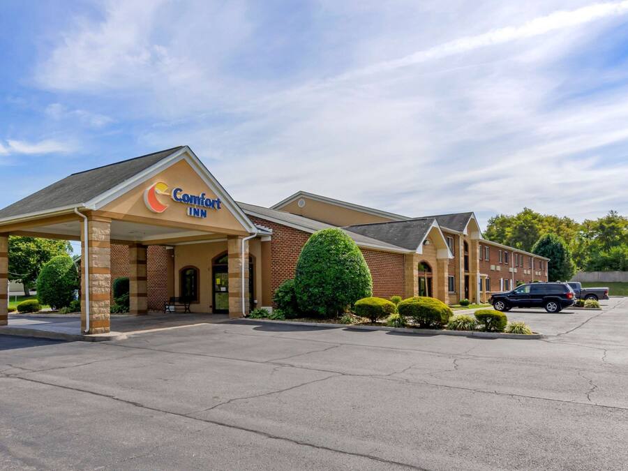 A Comfort Inn hotel with a brick facade, a covered entrance, and a parking lot.