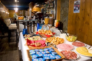 A buffet with various food items and a Christmas tree.