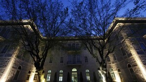 A historic building with arched windows and a symmetrical facade, illuminated by warm lighting. - Grand Kadri Hotel (Zahlé)